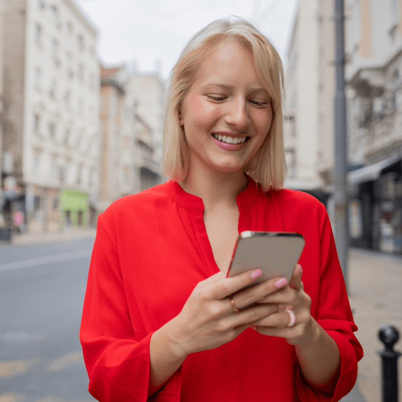 Executive-Onboarding-Landing-Directions A new leader receiving onboarding coaching via Career Navigator on her phone. She is happy, and is confident about her future.