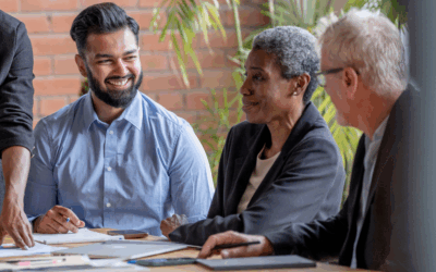 Senior executives collaborating in a modern office, representing executive career transitions and outplacement support.